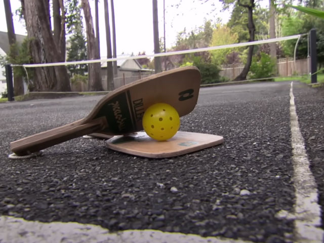 The original Pickleball court on Bainbridge Island, Washington with two paddles and ball